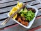 Salmon poke bowl with rice red quinoa edamame mango chopsticks