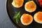 Salmon red caviar toast. Christmas canape or toast with red caviar on black plate on dark background. Idea to xmas snack. Gourmet