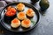 Salmon red caviar toast. Christmas canape or toast with red caviar on black plate on dark background. Idea to xmas snack. Gourmet