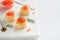 Salmon red caviar toast. Christmas canape or toast with red caviar on white plate on light background. Idea to xmas snack