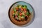 Salmon Salad. Salted salmon, mixed salad, grapefruit, Parmesan cheese, pine nuts in the dark plate. European cuisine. The work of