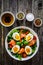 Salmon salad - smoked salmon hard boiled eggs and green vegetables on wooden table