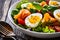 Salmon salad - smoked salmon hard boiled eggs and green vegetables on wooden table