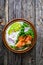 Salmon salad - smoked salmon white rice, avocado and green vegetables on wooden table, top view