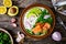 Salmon salad - smoked salmon white rice, avocado and green vegetables on wooden table, top view