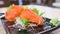 Salmon sashimi on a dish with vegetables