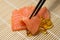Salmon Sashimi mixed with Fish oil capsules with chopstick grab