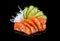 Salmon sashimi over black background