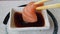 Salmon sashimi in soy sauce bowl with chopstick