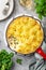Salmon  shepherd`s pie. Fish in creamy sauce , mashed potatoes and vegetables casserole in enamel cast iron pan