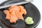 Salmon slices with wasabi