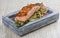 Salmon sous vide on a block of himalayan salt. On white background