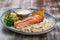 Salmon steak with cheese sauce, blanched vegetables and wild rice