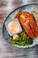 Salmon steak with cheese sauce, blanched vegetables and wild rice