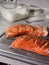 Salmon steak with salt on a gray cutting board