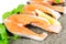 Salmon on stone with basil and lemon isolated