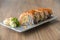 Salmon sushi rolls stuffed with salmon, avocado, topping salmon roe and spicy cream sauce. Japanese food style