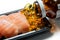 Salmon sushi served with fish oil pills poured from brown bottle