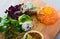 Salmon tartar with balsamic, greens, lemon, quail egg on wooden desk