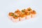 Salmon Tataki Sushi Roll pieces isolated on gray background with marinated salmon and green onion scallions on top