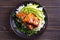 Salmon teriyaki rice bowl with spinach and avocado.