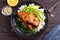 Salmon teriyaki rice bowl with spinach and avocado.