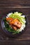 Salmon teriyaki rice bowl with spinach and avocado.