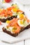 Salmon toast with cream cheese, cucumber and egg. Delicious lunch, healthy food, fish sandwich, diet snack