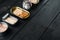 Salmon, tuna, trout mackerel and anchovy - Canned fish in tin cans, on black wooden table background, with copyspace  and space