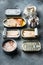 Salmon, tuna, trout mackerel and anchovy - Canned fish in tin cans, on gray background