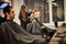 Salon. Man in a barber chair. The hairdresser serves the client in the barbershop. The concept of male cosmetology