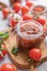 Salsa or adjika sauce is a traditional Mexican or Caucasus sauce with tomatoes and hot peppers on a light background with fresh