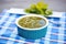 salsa verde in a square dish, blue tablecloth