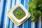 salsa verde in a square dish, blue tablecloth
