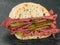 Salt Beef or Pastrami Cold Meat With Gherkins in a Ciabatta Bread Roll or