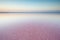 Salt and Brine of a pink lake, colored by microalgae Dunaliella salina at sunset