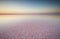 Salt and Brine of a pink lake, colored by microalgae Dunaliella salina at sunset