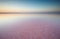 Salt and Brine of a pink lake, colored by microalgae Dunaliella salina at sunset