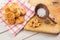 Salt and cumin snacks or pastries with grinder and wooden spoon on white background, product photography for bakery shop, baking