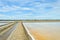 Salt evaporation pond against blue sky