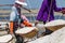 Salt field worker carrying salt with traditional shoulder pole with baskets during salt harvest