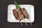 Salt grilled beef skewers on a dining table