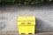 Salt grit yellow container for winter road safety on council road uk