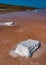 Salt Lake. Self-settling sodium chloride salt on rocks near the shore. Hypersaline water