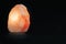 Salt lamp isolated against a black background. Mindfulness concept and esoterism. Empty copy space