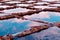 Salt making spot in Gozo island, Malta. Pans with water of vibrant colours at sunset time