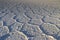 Salt pattern at sunset in the salar of Uyuni .