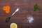 Salt, pepper, melchior spoon and vegetables on old wood background