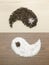 Salt and pepper on wooden background as yin and yang