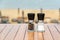 Salt and peppercorn grinder bottles on cafe table near beach